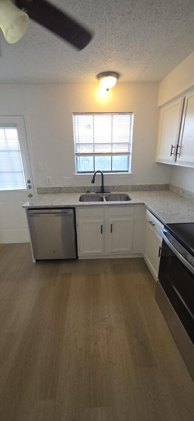 Building Photo - Beautifully remodeled first-floor condo with fence yard & carport!
