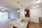 Step into a world of contemporary elegance and effortless living at 4320 N Towne Ct, Windsor WI. This stunning 640 square foot apartment is a testament to modern design and smart living. As you enter, you're greeted by an open-concept living area that seamlessly blends comfort with style. The spacious living room, bathed in natural light from large windows, offers a perfect backdrop for both relaxation and entertaining.

The heart of this home is the luxurious kitchen, a culinary enthusiast's dream. Boasting sleek stainless steel appliances, rich wood cabinetry, and striking granite countertops, it's a space that inspires creativity and gourmet adventures. The elegant pendant lighting adds a touch of sophistication, making meal preparation a joy.

The generously sized 140 square foot bedroom is a serene retreat, offering ample space for rest and rejuvenation. With plush carpeting underfoot and large windows framing picturesque views, it's a sanctuary of comfort and tranquility.

The bathroom is a model of modern efficiency, featuring a spacious vanity, ample storage, and a large mirror. The warm wood tones of the cabinetry complement the cool, contemporary fixtures, creating a harmonious blend of style and functionality.

Throughout the apartment, you'll find thoughtful touches that elevate everyday living. The ceiling fan in the living area ensures comfort year-round, while the closet provides valuable storage space. This home isn't just a place to live – it's a launchpad for your aspirations, a space where you can build the life you've always dreamed of. Welcome home to modern luxury and endless possibilities.