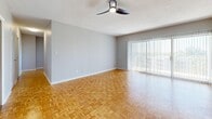 Located in the historic Central Gardens neighborhood of Memphis, TN, this two-bedroom, one-bathroom residence offers a functional and well-appointed single-floor layout. Throughout the living areas and bedrooms, warm-toned parquet wood flooring adds a classic, distinctive character to the space. The living area is generously sized, featuring a ceiling fan and a large sliding glass door dressed with vertical blinds that floods the room with natural light and provides outdoor views.

The kitchen is efficiently designed with white cabinetry, dark granite countertops, tile flooring, a stainless steel dishwasher, and a modern faucet at the sink — offering both practicality and style. Both bedrooms continue the parquet flooring theme and are equipped with ceiling fans. Each room benefits from natural light through sizable windows with blinds. The primary bedroom includes a closet, while the second bedroom also offers comfortable proportions. A hallway connects the rooms, contributing to a logical and easy-to-navigate floor plan.

The full bathroom features a tiled tub-shower combination with white wall tiles, providing a clean and classic finish. Two entrance points add convenience and accessibility. Overall, the space presents a cohesive, neutral palette with functional details throughout.
