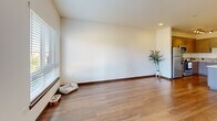 Located at 580 8th Ave NE in Issaquah, WA, this well-appointed 2-bedroom, 2-bathroom residence offers a thoughtfully designed single-level floor plan. The open-concept kitchen and living area serves as the heart of the home, showcasing warm hardwood-style flooring, contemporary two-tone cabinetry, a mosaic tile backsplash, and a full suite of stainless steel appliances. A central kitchen island with pendant lighting above provides additional prep space and casual seating. The living room extends naturally from the kitchen, bathed in natural light from large windows that frame views of the surrounding Issaquah hills. A private balcony offers a serene outdoor retreat with scenic mountain vistas. The spacious primary bedroom features plush carpeting, a generous walk-in closet with built-in shelving, and its own dedicated bathroom. The second bedroom is equally comfortable, complete with carpeting, a closet, and a window with mountain views. Both bathrooms are finished with wood-toned vanities and herringbone-patterned tile flooring. Additional highlights include three closets throughout, a dedicated laundry area, and a connecting hallway that ties the layout together for efficient, practical living.
