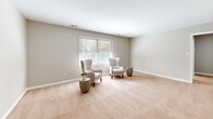 Located at 230 Pinecrest Dr in Fayetteville, NC, this single-story, 2-bedroom, 2-bathroom home offers a well-organized and functional layout across a comfortable footprint. The neutral gray and beige color palette creates a cohesive, calming atmosphere throughout.

The living room is generously sized, featuring plush wall-to-wall carpeting, soft natural light from multiple windows with blinds, and a textured ceiling. It flows openly toward the dining area, which is anchored by a pendant light fixture and provides views of the screened porch — a rustic outdoor retreat with wood-panel walls and lattice detailing.

The kitchen includes light wood-tone flooring, white cabinetry, and stainless steel appliances, offering a clean and practical workspace. Both bedrooms are carpeted and equipped with ceiling fans with integrated lighting, natural window light, and generous closet access — six closets are distributed throughout the home for abundant storage.

The primary bedroom is spacious and well-proportioned. The two bathrooms are clean and functional; one features a white shaker-style vanity, a round mirror with modern matte black fixtures, tile flooring, and a window for natural light, while the second includes a tub-shower combination. The hallway connects the rooms efficiently, contributing to a practical and comfortable single-level living experience.