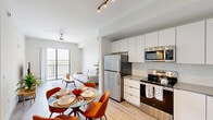 Located at 3300 Boutwell Rd in Lake Worth Beach, Florida, this well-designed one-bedroom, one-bathroom residence offers a thoughtfully organized floor plan across a single level. The open-concept living and dining area flows seamlessly into a modern kitchen, creating a cohesive and functional shared space. Light wood-tone flooring runs throughout the main living areas, enhancing the bright, airy atmosphere.

The kitchen is equipped with stainless steel appliances — including a refrigerator, range, microwave, and dishwasher — complemented by sleek white cabinetry that extends to the ceiling for ample storage, a tile backsplash, and neutral countertops. Track lighting above the dining area adds a contemporary touch.

The living room is anchored by a ceiling fan and features a sliding glass door that opens to a private balcony, offering open outdoor views — a standout feature of this Florida residence. Natural light fills the space generously.

The bedroom is a comfortable retreat with a walk-in closet, ceiling fan, and a window framing the same expansive views. Carpet flooring adds warmth underfoot. The bathroom is finished with a frameless glass walk-in shower, white subway tile walls, mosaic tile flooring, and matte black fixtures for a clean, modern aesthetic.