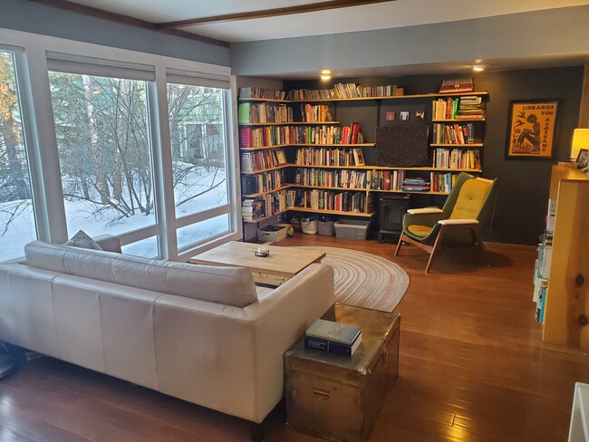 Living room with wall of windows to the court yard - 817 W 19th Ave