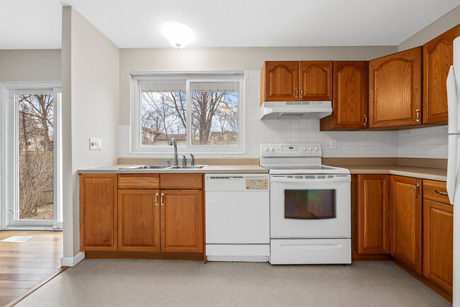 Kitchen includes stove, dishwasher and refrigerator. - 215 Shadyoak Dr