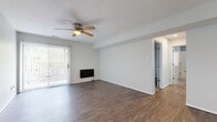 Located at 3924 SW Twilight Dr in Topeka, Kansas, this single-story, 3-bedroom, 1-bathroom home offers a well-organized layout across a comfortable footprint. The living room serves as the heart of the home, featuring wood-look vinyl flooring, a ceiling fan with light fixture, a wall-mounted fireplace, and a sliding glass door with vertical blinds that fills the space with natural light. An open sightline connects the living area to the hallways leading to the rest of the home. The galley-style kitchen is efficiently designed with gray cabinetry, light countertops, a stainless steel sink, and white appliances including a refrigerator, dishwasher, and range. Wood-look flooring continues through the kitchen for easy maintenance. The spacious primary bedroom features plush carpet, a large bay window for ample natural light, and a dedicated walk-in closet with built-in shelving. The additional bedrooms are also carpeted and include generous windows and closet access. The bathroom is equipped with a glass-enclosed walk-in shower with tile surround and chrome fixtures. Two hallways connect the rooms efficiently, and neutral gray-toned walls throughout create a clean, cohesive aesthetic.