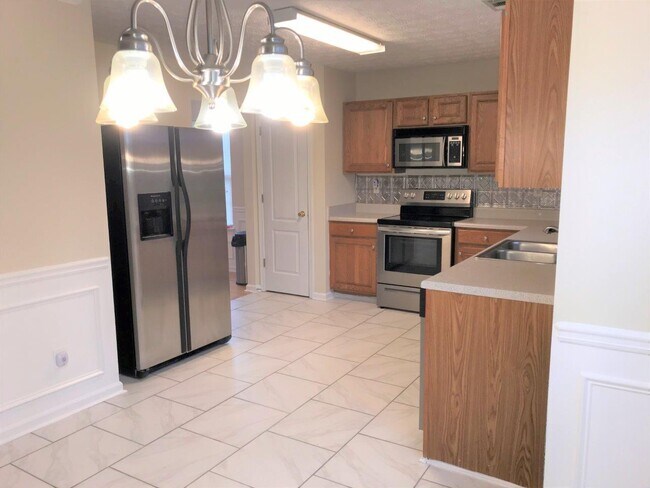 Large kitchen with stainless steel appliances. - 4376 Newton Estates Trl