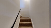 Located at 1100 Village Dr in Somerset, NJ, this two-bedroom, one-bathroom residence is spread across two floors, offering a practical and comfortable layout. The main living level hosts the majority of the space, including a living room, kitchen, two bedrooms, a full bathroom, and a hallway connected by a staircase.

The kitchen features warm honey-toned wood cabinetry with ample upper and lower storage, light countertops, tile flooring, and a full suite of white appliances including a gas range, dishwasher, and refrigerator. A window above the sink brings in natural light, enhancing the functional workspace.

Both bedrooms are finished with neutral carpet and light-toned walls, creating a calm and versatile atmosphere. The spacious primary bedroom features multiple windows that frame views of surrounding greenery, flooding the room with natural light. It also includes a large sliding-door closet for generous storage. The second bedroom is equally well-lit with its own window and closet access.

The bathroom is finished with beige ceramic wall tiles surrounding a full soaking tub and shower combination, complemented by classic chrome fixtures. The clean, neutral palette throughout the home provides a welcoming canvas ready for personalization.