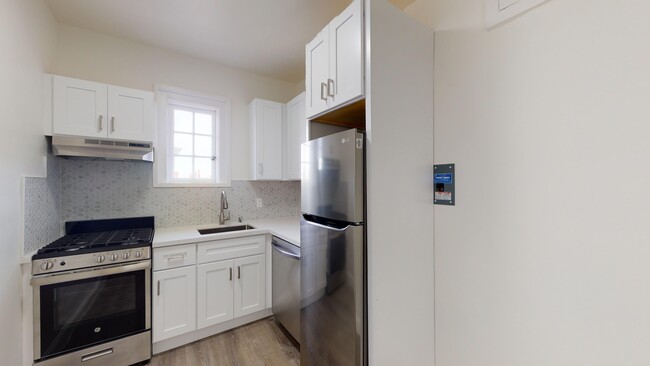 Kitchen with cabinets, refrigerator, stove, range hood, and sink - 2500 Durant Avenue