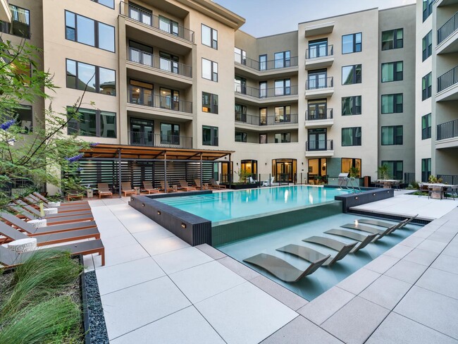 Relax in style at Modera Trailhead’s resort-inspired pool, featuring in-water loungers and ample deck seating for sun-soaked days in Dallas. - Modera Trailhead