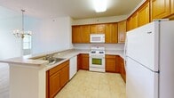 Located at 1055 Cetronia Rd in Breinigsville, PA, this two-bedroom, two-bathroom single-floor residence offers a well-designed, functional layout. The kitchen is outfitted with warm honey-toned cabinetry, light countertops, tile flooring, and white appliances including a gas range, built-in microwave, dishwasher, and refrigerator. A peninsula with a double sink connects the kitchen to the living and dining areas, making it ideal for both daily use and entertaining. The living area features soaring vaulted ceilings, a ceiling fan, and a large multi-pane window that fills the space with natural light and offers outdoor views. Plush wall-to-wall carpeting flows throughout the living space and both bedrooms. The generously sized primary bedroom features a tray ceiling, large windows with outdoor views, and dedicated closet space. The second bedroom is equally well-appointed with natural light and carpeted flooring. Both bathrooms are finished with tile flooring, white vanities with single sinks, large mirrors, and chrome fixtures. The primary bath includes a glass-enclosed shower stall, while the second bath provides a clean, efficient layout. Two closets add to the overall storage of this comfortable and inviting residence.