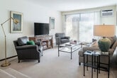 Located at 238 Randolph Dr in Madison, WI, this well-appointed 2-bedroom, 2-bathroom single-floor residence offers a thoughtfully designed layout with a warm, neutral palette throughout. The open-concept living and dining area is the heart of the home, featuring soft carpeting, a ceiling fan, and a seamless flow between the sitting area and dining space. A peninsula counter connects the kitchen to the dining area, providing both a functional workspace and casual seating. The kitchen is outfitted with white cabinetry, ample counter space, full appliances including a range and dishwasher, and a double stainless steel sink — all finished with easy-care flooring. A second living area offers additional flexible space, complete with louvered closet doors and room for a variety of uses. The spacious primary bedroom features natural light from a window, plush carpet, and generous closet access. Both bathrooms are finished with wide vanity countertops, large mirrors, and white cabinetry, maintaining a clean and consistent aesthetic. A hallway connects the private areas of the home efficiently. Throughout, the design emphasizes light tones, practical storage, and a comfortable, livable ambiance ideal for everyday Madison living.