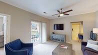 This single-story residence in Raleigh, NC is thoughtfully designed with a functional and comfortable layout. The living room is bright and welcoming, finished with plush carpet, crown molding, and a ceiling fan. A wall-mounted flat-screen TV and a sliding glass door leading to a private balcony — complete with outdoor seating — make it an ideal space for both relaxing and entertaining.

The kitchen is well-equipped with rich dark wood cabinetry, granite countertops, tile flooring, and black appliances including a refrigerator, range, and microwave. An open layout connects it seamlessly to the main living areas.

The bedrooms offer carpeted floors, ceiling fans, and natural light through well-placed windows with blinds. Each room includes closet storage, and one features a built-in desk nook with shelving — ideal as a home office area.

The bathroom is clean and functional, featuring tile flooring, a tub-shower combination, a granite-topped vanity with dark wood cabinetry, and a large mirror. An in-unit laundry area provides added convenience with a full-size washer and dryer, plus overhead wire shelving for storage.

Overall, the space offers a neutral color palette, practical finishes, and a well-organized floor plan suited for everyday living in the heart of Raleigh.