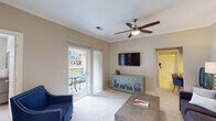 This single-story residence in Raleigh, NC is thoughtfully designed with a functional and comfortable layout. The living room is bright and welcoming, finished with plush carpet, crown molding, and a ceiling fan. A wall-mounted flat-screen TV and a sliding glass door leading to a private balcony — complete with outdoor seating — make it an ideal space for both relaxing and entertaining.

The kitchen is well-equipped with rich dark wood cabinetry, granite countertops, tile flooring, and black appliances including a refrigerator, range, and microwave. An open layout connects it seamlessly to the main living areas.

The bedrooms offer carpeted floors, ceiling fans, and natural light through well-placed windows with blinds. Each room includes closet storage, and one features a built-in desk nook with shelving — ideal as a home office area.

The bathroom is clean and functional, featuring tile flooring, a tub-shower combination, a granite-topped vanity with dark wood cabinetry, and a large mirror. An in-unit laundry area provides added convenience with a full-size washer and dryer, plus overhead wire shelving for storage.

Overall, the space offers a neutral color palette, practical finishes, and a well-organized floor plan suited for everyday living in the heart of Raleigh.