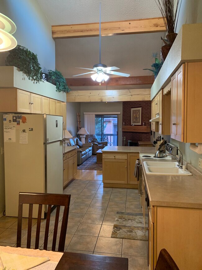 View from dining area-tile in kitchen, laminate wood in living room - 2934 Holly Ave