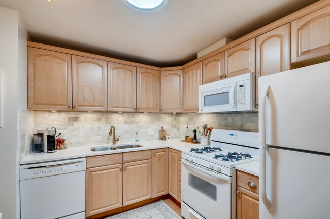 Kitchen with marble tile backsplash - 4860 Park Commons Dr