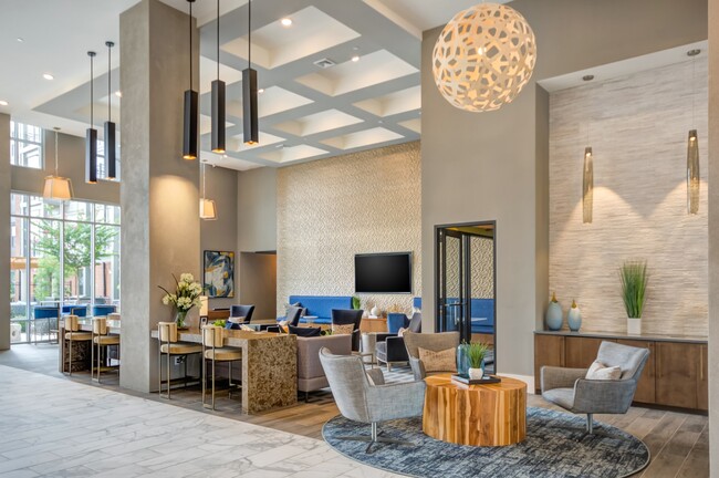 A chic and inviting lounge space featuring modern decor, cozy seating areas, and elegant lighting. - The Heights at Goose Creek Village