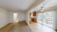 Located at 910 Camino Pescadero in Goleta, California, this two-bedroom, one-bathroom unit offers a practical and well-organized single-floor layout. The living area features neutral carpet flooring, a textured ceiling, and a classic paneled front door with a transom window that allows natural light to filter in. Baseboard heaters are present throughout, ensuring consistent warmth. A ceiling fan adds comfort to the connected living space.

The galley-style kitchen is efficiently designed with warm oak cabinetry lining both walls, offering generous storage above and below. Tile countertops, a white gas range, refrigerator, and a double sink beneath a window complete the space, making it both functional and well-equipped.

The primary bedroom is a comfortable size, featuring plush carpet, a large window with views of the surrounding greenery, and a set of sliding double closet doors providing ample storage. A wall-mounted heater adds to the room's practicality. The second bedroom shares a similar clean, carpeted aesthetic.

The bathroom is well-appointed with warm terracotta floor tiles, a full tub-shower combination surrounded by classic tile surround, an oak vanity with a built-in sink, and a small window above the tub for natural light. The unit is part of a well-maintained multi-unit property with landscaped grounds in a convenient Goleta neighborhood.