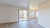 Located at 628 SW 257th Ave in Troutdale, Oregon, this 2-bedroom, 1-bathroom single-story home offers a practical and comfortable layout across a well-utilized floor plan. The living and dining area is bright and open, featuring wood-look flooring, a textured ceiling, and a ceiling fan. A large sliding glass door floods the space with natural light and provides direct access to a private patio with outdoor views of lush greenery. The galley-style kitchen is efficiently designed with ample upper and lower cabinetry featuring wood-trimmed white doors, granite-style countertops, a double sink, and white appliances including a dishwasher, refrigerator, and electric range. The hallway connects the main living areas to the bedrooms and bathroom, with closet access conveniently situated along the corridor. The two bedrooms offer comfortable proportions — the primary bedroom includes a spacious reach-in closet, while both rooms feature neutral carpet and natural light from windows with blinds. The full bathroom includes a wide vanity with a granite-style countertop, a large mirror, and a shower/tub combination. Wood-look flooring runs throughout the main living spaces, creating a cohesive and easy-to-maintain interior.
