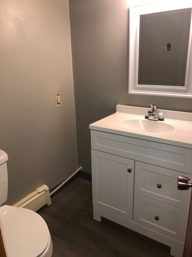 Newly updated bathroom, including new vanity, toilet and flooring. - 210 27th St NE