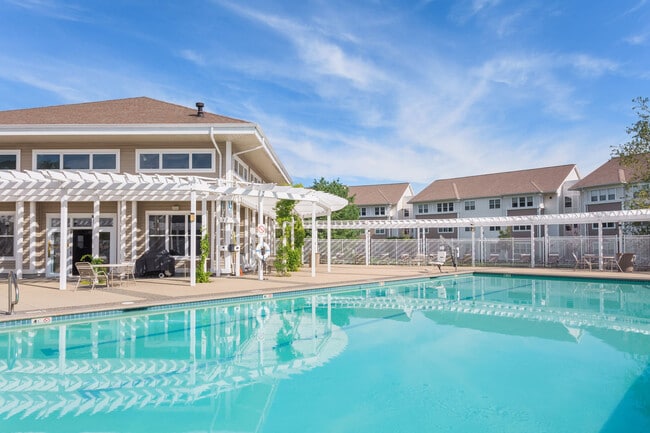 Resort-Style Pool and Pergola and Chaise Lounge Chairs - Chestnut Farm Apartments