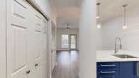Located at 1008 Grayson Pl in Decatur, GA, this well-designed one-bedroom, one-bathroom unit offers a smart and functional layout across a single floor. Hardwood-style flooring flows consistently throughout, complementing the crisp white walls and clean architectural lines found in every room.

The kitchen is a standout feature, outfitted with bold navy cabinetry, white quartz countertops, stainless steel appliances including a refrigerator, range, microwave, and dishwasher, and elegant pendant lighting that hangs above a peninsula-style breakfast bar — ideal for casual dining or entertaining.

The open entryway leads to the living area, which benefits from generous natural light through large windows and a glass door, along with a ceiling fan for year-round comfort. Louvered closet doors add a classic touch along the hallway.

The bedroom is a comfortable, well-lit retreat with its own ceiling fan, a wide window overlooking the outdoors, and direct access to the bathroom. The bathroom features a full soaking tub with tiled surround, a navy vanity with quartz countertop, and light wood-style flooring that ties the space together cohesively. A dedicated closet completes the unit's practical storage offerings.