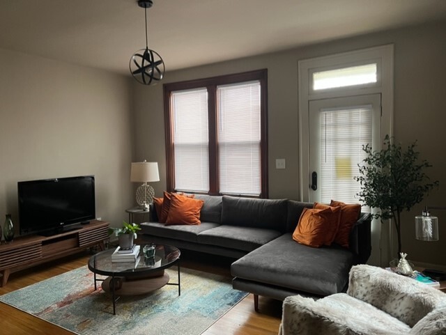 Living room with original fireplace and oak wood floors flooring - 215 Thurman Ave