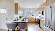 This contemporary two-story residence boasts 1360 square feet of thoughtfully designed living space. The ground floor, encompassing 1060 square feet, houses the main living areas. A modern kitchen with light wood cabinetry, quartz countertops, and stainless steel appliances opens to a bright living room, creating an ideal space for entertaining. Large windows throughout ensure abundant natural light, while sleek laminate flooring adds a touch of elegance.

The home features five bedrooms, including a spacious 180-square-foot primary suite, providing ample room for rest and relaxation. Two well-appointed bathrooms showcase modern fixtures and finishes. The upper floor, measuring 300 square feet, likely contains additional bedrooms or a versatile bonus space.

An attached garage offers convenient parking and storage solutions. The property also includes a dedicated closet area with built-in shelving for organized storage. Multiple hallways ensure easy navigation throughout the home. With its neutral color palette and clean lines, this residence presents a blank canvas for personalization, appealing to a wide range of aesthetic preferences.