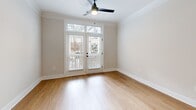 Located at 1155 Lavista Rd NE in Atlanta, GA, this thoughtfully designed one-bedroom, one-bathroom residence offers a clean, modern aesthetic with warm, inviting finishes across a single floor. Light-toned hardwood flooring runs throughout, complemented by crown molding and crisp white walls that create a bright and cohesive atmosphere.

The open-concept living, dining, and kitchen area serves as the heart of the home. The kitchen is well-appointed with flat-front cabinetry in a warm wood-grain finish, white subway tile backsplash, light quartz countertops, and a full suite of stainless steel appliances including a gas range, microwave, dishwasher, and French door refrigerator. A peninsula with an undermount sink and matte black fixtures provides additional prep space and casual seating. Statement pendant lights with black-and-gold interiors hang above, adding a contemporary touch. The adjacent living area receives natural light through large windows and includes a ceiling fan.

The bedroom is a comfortable, well-proportioned retreat featuring natural light from dual windows, a ceiling fan, and hardwood flooring. Three closets offer generous storage throughout the unit. The bathroom features a wood-tone vanity, white quartz countertop, matte black fixtures, a framed mirror, and a tiled walk-in shower. A dedicated laundry area and utility room add everyday convenience.