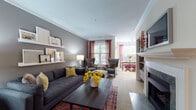 Located at Sterling Bay Lane in Cornelius, NC, this thoughtfully designed single-floor residence offers a cohesive blend of comfort and style throughout its well-proportioned layout. The living area serves as the heart of the home, featuring crown molding, a classic fireplace, and an abundance of natural light streaming through large windows dressed with rich, colorful drapes. Neutral gray walls, floating art shelves, and plush carpeting create a warm and curated atmosphere. The kitchen is a standout space, showcasing rich dark cabinetry, granite countertops, stainless steel appliances, and warm hardwood flooring. A peninsula provides additional prep space and opens the kitchen to the adjoining areas. The bedrooms offer restful retreats, each featuring plush carpeting and distinct accent walls — one adorned in deep teal with bold artwork, another in a soft aqua hue with dual nightstand lighting. The bathrooms are finished with classic white tile, including a soaking tub, a separate glass-enclosed shower, and dark vanity cabinetry with chrome hardware. A dedicated laundry area adds everyday convenience. Together, the spaces offer a refined, livable environment in a desirable lakeside community.