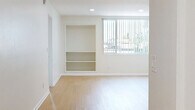 Located at 5505 Zelzah Ave in the Encino neighborhood of Los Angeles, this 2-bedroom, 4-bathroom residence offers a well-organized, single-level layout designed for comfortable living. Light wood flooring flows consistently throughout, creating a bright and cohesive aesthetic across every room.

The kitchen is efficiently designed in a galley style, featuring white cabinetry, gray countertops, stainless steel appliances including a gas range, dishwasher, and refrigerator, along with an in-unit washer for added convenience. The adjoining living room is open and airy, with built-in shelving and large windows dressed with vertical blinds that invite generous natural light and outdoor greenery views.

Both bedrooms are well-proportioned, with the primary bedroom offering a spacious walk-in closet equipped with built-in shelving and hanging rods. The second bedroom features mirrored sliding closet doors that enhance the sense of space. The four bathrooms are clean and functional; the primary bath stands out with a long dual-sink vanity, dark countertops, white cabinetry, and stylish round mirrors. Additional bathrooms provide practical, well-maintained facilities. A central hallway connects all areas seamlessly, contributing to an efficient and comfortable floor plan.