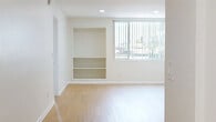 Located at 5505 Zelzah Ave in the Encino neighborhood of Los Angeles, this 2-bedroom, 4-bathroom residence offers a well-organized, single-level layout designed for comfortable living. Light wood flooring flows consistently throughout, creating a bright and cohesive aesthetic across every room.

The kitchen is efficiently designed in a galley style, featuring white cabinetry, gray countertops, stainless steel appliances including a gas range, dishwasher, and refrigerator, along with an in-unit washer for added convenience. The adjoining living room is open and airy, with built-in shelving and large windows dressed with vertical blinds that invite generous natural light and outdoor greenery views.

Both bedrooms are well-proportioned, with the primary bedroom offering a spacious walk-in closet equipped with built-in shelving and hanging rods. The second bedroom features mirrored sliding closet doors that enhance the sense of space. The four bathrooms are clean and functional; the primary bath stands out with a long dual-sink vanity, dark countertops, white cabinetry, and stylish round mirrors. Additional bathrooms provide practical, well-maintained facilities. A central hallway connects all areas seamlessly, contributing to an efficient and comfortable floor plan.