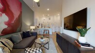 Located in Charlotte's sought-after Dilworth neighborhood, this single-floor residence on W Tremont Avenue offers a thoughtfully designed open-concept layout with contemporary finishes throughout. Light wood-style flooring flows seamlessly across the living, dining, and kitchen areas, creating a cohesive and airy feel.

The living room serves as a welcoming centerpiece, featuring elevated ceilings, a ceiling fan, and a glass door that opens to an outdoor area, inviting natural light to fill the space. A bold accent wall adds a striking visual element, complemented by stylish pendant lighting.

The kitchen is outfitted with white shaker-style cabinetry with matte black hardware, white quartz countertops, a subway tile backsplash, and a full suite of stainless steel appliances including a range, over-the-range microwave, and refrigerator. A matte black faucet anchors the undermount sink.

The bedroom offers a calm retreat with a ceiling fan, natural light from a window, and direct access to a well-organized walk-in closet featuring multi-tiered wire shelving. A dedicated laundry area with a stacked washer and dryer adds everyday convenience.

The bathroom is finished with slate-toned walls, white cabinetry, and a tub-shower combination, maintaining the clean, modern aesthetic found throughout the residence.