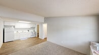 Located at 1801 Sugartree Circle in New Smyrna Beach, Florida, this single-floor, one-bedroom, one-bathroom unit offers a practical and functional layout. The open-concept main area seamlessly combines the living room, dining room, and kitchen into one continuous space. The kitchen features white cabinetry, a white appliance suite including a range, and a classic under-cabinet light, all set over light wood-look flooring. The living area transitions to soft carpet, providing a comfortable feel underfoot throughout the shared living spaces.

The bedroom is a well-proportioned room with plush carpeting, a ceiling fan with a light fixture, a natural window for outside views and natural light, and a bifold closet door providing organized storage. An additional closet is found within the unit, offering further storage convenience.

The bathroom includes a vanity with white cabinetry, a toilet, and a full bathtub with a shower curtain, all set on wood-look flooring. A hallway connects the main rooms and leads to a dedicated laundry area. The living room is anchored by a large window overlooking the outdoors, allowing natural light to fill the space. Textured ceilings are consistent throughout, and the neutral gray-toned walls create a clean, versatile backdrop throughout this efficiently designed home.
