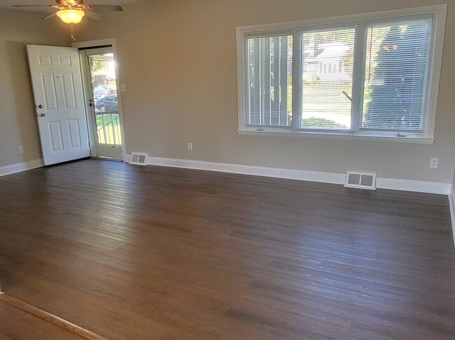 Living room with ceiling fan, large window, front door to screened in porch - 1429 Virginia Ave