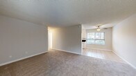 Located at 4929 Del Monte Avenue in the Point Loma neighborhood of San Diego, this single-floor, two-bedroom residence offers a practical and well-organized layout. The open-concept living and dining area flows seamlessly into the kitchen, creating a connected and functional common space. The living room features neutral-toned carpet, a textured ceiling, and a front entry door flanked by a window that invites natural light. A ceiling fan with a light fixture enhances comfort in the adjoining kitchen and dining area.

The kitchen is equipped with white cabinetry, dark countertops, black appliances including a range and refrigerator, a single-basin sink, and light tile flooring. A window above the sink provides additional natural light and outdoor views.

Both bedrooms are carpeted and finished with neutral walls and textured ceilings. The primary bedroom is a comfortable size and includes mirrored sliding closet doors, which enhance the sense of space and brightness. The second bedroom also features a window and dedicated closet. A hallway connects the bedrooms and living areas, contributing to a clear and efficient floor plan. Two closets throughout the unit provide ample storage for daily needs.