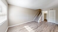 Located at 1917 Heathcliff Dr in Dalton, GA, this two-story, 2-bedroom, 4-bathroom home offers a practical and comfortable layout spread evenly across two floors. The main level features an open living room with light-toned luxury vinyl plank flooring that reflects natural light from the windows, creating a bright and welcoming atmosphere. A staircase with white balusters connects the floors seamlessly. The kitchen is well-equipped with white cabinetry, light countertops, a black electric range with overhead ventilation, a stainless steel refrigerator, and a dishwasher — all set atop wood-style flooring. The bathrooms are clean and functional, featuring white vanities, updated light fixtures, mirrors, and wood-style flooring, with at least one bath offering a tub-shower combination. Both bedrooms are located upstairs and feature plush carpeting, neutral wall tones, and windows that allow in natural light. The primary bedroom offers a generous footprint, ideal for a full furniture arrangement. Textured ceilings are consistent throughout the home. With hallways, a dedicated closet, and four bathrooms, this home offers practical convenience for everyday living in a well-maintained residential setting.