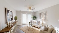 This single-floor residence in Jeffersonville, Indiana, offers a thoughtfully designed layout that balances comfort and functionality. The living area serves as the centerpiece of the home, featuring wood-style flooring, a ceiling fan with integrated lighting, and French doors that fill the space with natural light while providing outdoor access. Neutral gray walls and clean white trim create a bright, welcoming atmosphere throughout.

The kitchen is outfitted with dark espresso cabinetry, granite countertops, a deep double-basin stainless steel sink, and stainless steel appliances, including a refrigerator, range, and over-the-range microwave. Wood-style flooring continues through this space, tying it cohesively to the rest of the home.

The two bedrooms feature the same warm wood-style flooring and neutral tones, with windows allowing natural light to filter in. The layout of the bedrooms provides convenient access to the bathrooms. One bathroom includes a full tub-shower combination, while the other features a dark vanity with granite countertops, a large mirror, and stylish overhead lighting. Both bathrooms are finished in clean, neutral tones that complement the overall design of the residence.