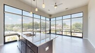 Located at 644 N Main St in Greenville, SC, this 2-bedroom, 2-bathroom residence offers a modern and functional single-floor layout with quality finishes throughout. The living area is a standout feature, boasting dramatic floor-to-ceiling windows that wrap around two walls, flooding the space with natural light and providing sweeping views of the surrounding Greenville streetscape and treetops. Durable wood-style plank flooring anchors the open living and dining area, which connects seamlessly to a kitchen featuring granite countertops and pendant lighting.

Both bedrooms are carpeted for comfort and include sliding glass doors that open to a private balcony with outdoor views. The generously sized primary bedroom offers a walk-in closet equipped with multi-tiered wire shelving for ample storage. The second bedroom is well-proportioned with its own access to natural light. Each of the two full bathrooms features wood-style flooring, a full soaking tub and shower combo with tile surround, and a dark-finish vanity topped with granite. A hallway connects all rooms efficiently, completing this clean, contemporary layout designed for comfortable everyday living.