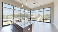 Located at 644 N Main St in Greenville, SC, this 2-bedroom, 2-bathroom residence offers a modern and functional single-floor layout with quality finishes throughout. The living area is a standout feature, boasting dramatic floor-to-ceiling windows that wrap around two walls, flooding the space with natural light and providing sweeping views of the surrounding Greenville streetscape and treetops. Durable wood-style plank flooring anchors the open living and dining area, which connects seamlessly to a kitchen featuring granite countertops and pendant lighting.

Both bedrooms are carpeted for comfort and include sliding glass doors that open to a private balcony with outdoor views. The generously sized primary bedroom offers a walk-in closet equipped with multi-tiered wire shelving for ample storage. The second bedroom is well-proportioned with its own access to natural light. Each of the two full bathrooms features wood-style flooring, a full soaking tub and shower combo with tile surround, and a dark-finish vanity topped with granite. A hallway connects all rooms efficiently, completing this clean, contemporary layout designed for comfortable everyday living.