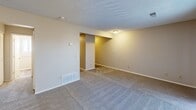 This 430 square foot apartment, located at 2722 S Topeka St in Wichita, Kansas, offers a thoughtfully designed single-floor layout. The space consists of one living room, one bathroom, and a closet, efficiently utilizing its compact footprint.

The living area is the focal point of the apartment, featuring neutral-toned walls and plush wall-to-wall carpeting. The room is illuminated by a central ceiling fixture and benefits from natural light filtering through vertical blinds. A recessed area suggests a potential dining or work nook, adding versatility to the space.

The bathroom, while not expansive, is functionally designed with a shower/tub combination. White fixtures and tiling create a clean, bright atmosphere. Built-in shelving provides convenient storage for toiletries and linens.

Throughout the apartment, the neutral color palette and textured ceiling contribute to a sense of openness, making the space feel larger than its actual square footage. The closet, though not visible in the images, adds valuable storage to the compact layout.

HVAC vents are strategically placed for efficient climate control, ensuring comfort throughout the seasons. The overall design prioritizes functionality and simplicity, making it an ideal space for a single occupant or couple seeking a low-maintenance, cozy living environment in Wichita.