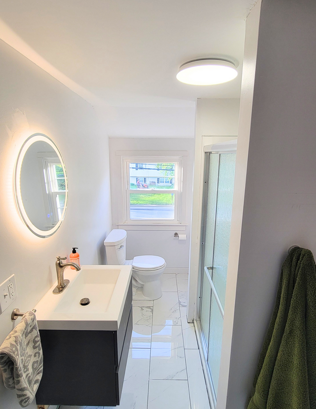 Newly renovated upstairs bathroom with tile flooring and stand-up shower. - 20 Kenyon Rd