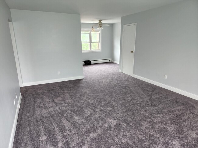Living room with view to dining area. - 87 Roseland Ave