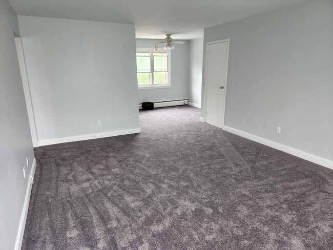 Living room with view to dining area. - 87 Roseland Ave