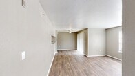 Located in Irving, TX, this single-floor, 2-bedroom, 2-bathroom residence offers a well-organized layout designed for comfortable everyday living. The open living area is finished with warm wood-look flooring that extends throughout the home, complemented by neutral taupe walls and a textured ceiling. A ceiling fan adds functionality, while a built-in pass-through counter connects the living area to the kitchen, enhancing the sense of openness. The galley-style kitchen is efficiently arranged with white cabinetry, laminate countertops, a stainless steel sink, and included appliances. A dedicated entrance and hallway provide a clear flow through the home. Both bedrooms feature the same wood-look flooring, neutral tones, and windows that allow natural light to filter in. The primary bedroom includes a spacious walk-in closet with wrap-around shelving and hanging rods for ample storage. A second closet serves the additional bedroom. Each of the two bathrooms is equipped with a tub-shower combination, vanity with storage, and laminate countertops. The overall ambiance is clean, functional, and move-in ready, offering a straightforward and practical living environment.