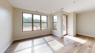 Located at 538 Bond Ave NW in Grand Rapids, Michigan, this well-appointed one-bedroom, two-bathroom unit offers a thoughtfully designed single-level layout. The open-concept kitchen and living area forms the heart of the space, where light wood-look flooring flows throughout. The kitchen is equipped with stainless steel appliances, including a range, microwave, and refrigerator, complemented by warm maple cabinetry, granite countertops, a tile floor, and a peninsula with a built-in sink — ideal for both cooking and casual dining. Track lighting overhead adds a modern touch. The living area is bathed in natural light from large windows that frame views of the surrounding Grand Rapids cityscape, with access to an outdoor area via a glass door. The spacious primary bedroom features wood-look flooring, a large window with city views, and direct access to a dedicated walk-in closet with wire shelving. The primary bathroom offers a double-sink vanity with granite countertops, maple cabinetry, tile flooring, and a soaking tub. A second full bathroom provides a single-sink granite vanity, tile flooring, and a toilet — well-suited for guests. Neutral wall tones throughout lend a clean, cohesive aesthetic to the entire unit.