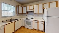 Located at 700 Township Road 179 in Bellefontaine, Ohio, this two-floor home offers a practical and comfortable layout spread across both levels. The kitchen is well-equipped with white cabinetry accented by warm wood trim, light hardwood flooring, a coil-top electric range, a dishwasher, a refrigerator, and a double basin sink. Ample upper and lower cabinet storage provides generous workspace, while windows allow natural light to brighten the area. The kitchen opens toward a adjoining living area, creating a connected, open feel between the spaces. Multiple bedrooms are found throughout the home, each featuring neutral carpet flooring, white walls with wood baseboard trim, and windows fitted with blinds that offer views of the surrounding neighborhood and natural landscape. The bedrooms are well-proportioned, providing comfortable living space. A full bathroom includes a tub and shower combination with a clean, white surround, tiled flooring in an earthy tone, and standard fixtures. Textured ceilings are present throughout much of the home, adding a classic residential character. The overall design is clean and straightforward, with a neutral color palette that provides a versatile backdrop throughout the interior.
