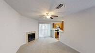 This single-floor, one-bedroom, one-bathroom unit in Birmingham, Alabama offers a practical and comfortable layout. The living room serves as the heart of the space, featuring soft wall-to-wall carpeting, a ceiling fan with light fixture, a textured ceiling, and a tile-surround wood-burning fireplace that adds a cozy focal point. A sliding glass door floods the room with natural light and provides outdoor access. The kitchen is efficiently designed with warm honey-toned wood cabinetry, white laminate countertops, stainless steel appliances including an electric range and refrigerator, a stainless steel sink, and durable hardwood-style flooring. It opens to a combined dining area, creating a connected and functional flow. The bedroom is a comfortable, carpeted retreat featuring two windows that bring in ample natural light and a textured ceiling. A dedicated closet provides practical storage. The bathroom includes a full tub-and-shower combination with white tile surround, hardwood-style flooring, and clean, neutral finishes throughout. The overall ambiance of the unit is bright and neutral, making it a versatile and move-in ready space.