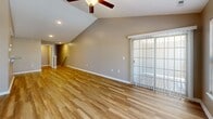 Located at 4720 Transit Rd in Depew, NY, this single-floor, 3-bedroom, 2-bathroom home offers a well-designed layout with a variety of functional and stylish features throughout. The open-concept living room and kitchen serve as the heart of the home, highlighted by vaulted ceilings, recessed lighting, and warm hardwood-style flooring. A ceiling fan adds comfort to the spacious living area, which features a sliding glass door that invites natural light and outdoor access. The kitchen is outfitted with rich dark cabinetry, granite countertops, stainless steel appliances, and a peninsula with pendant lighting and bar seating — ideal for both cooking and casual dining. The primary bedroom is generously sized, featuring plush carpeting, a ceiling fan, and a large window that fills the room with natural light. Additional bedrooms are similarly appointed with carpet flooring and ample natural light. The bathrooms include wood-look tile flooring and granite-topped dark vanities. A walk-in closet with wire shelving provides excellent storage. The dedicated laundry room comes equipped with washer and dryer hookups, while the attached garage offers convenient parking and additional storage space.