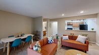 Located at 7311 Black Bay Ct in Indianapolis, Indiana, this 2-bedroom, 2-bathroom single-floor home offers a practical and well-organized layout. The entry hallway, finished with wood-look flooring and a textured ceiling, leads into a bright, open-concept living, dining, and kitchen area. The living room is filled with natural light from a large sliding glass door that offers outdoor views, while the dining area provides comfortable space for everyday meals. The kitchen features warm wood cabinetry, light stone-finish countertops with a breakfast bar, black appliances including a range and refrigerator, and a dishwasher — all efficiently arranged in a galley-style layout with wood-look tile flooring. The primary bedroom is a well-proportioned retreat with plush carpeting, a natural light window, and ample closet space. The second bedroom, also carpeted, is versatile and can serve as a guest room or home office. Both bathrooms include wood-toned vanities with light countertops and tub/shower combinations. Additional highlights include a dedicated laundry area, six closets for generous storage throughout, and a neutral warm-gray color palette that ties the entire home together cohesively.