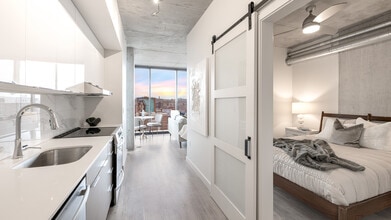 The kitchen and bedroom of The Lincoln at Three Light Luxury Apartments - Three Light Luxury Apartments